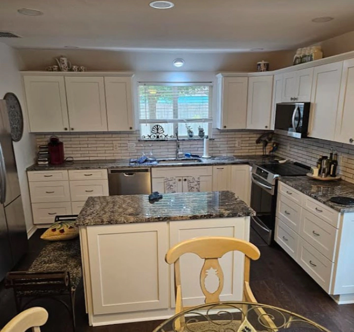 interior of a remodeled kitchen with cabinets and countertop